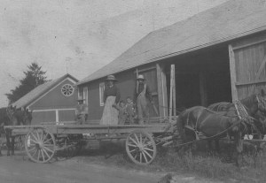 Farm family on hay wagon. Late 19th, early 20th Century.